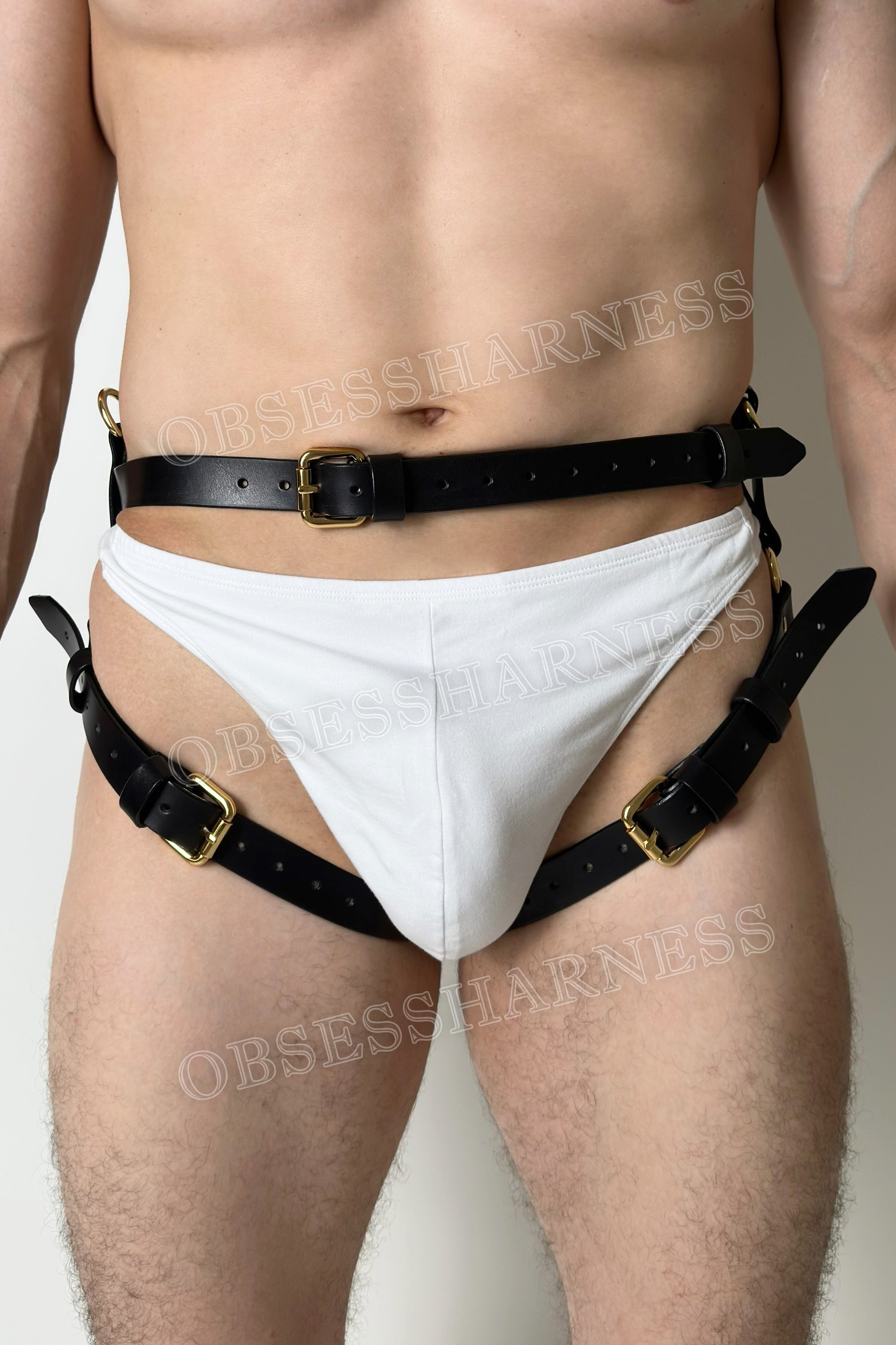 full body male harness leather gear with tight garters and cuffs for submissine in bdsm