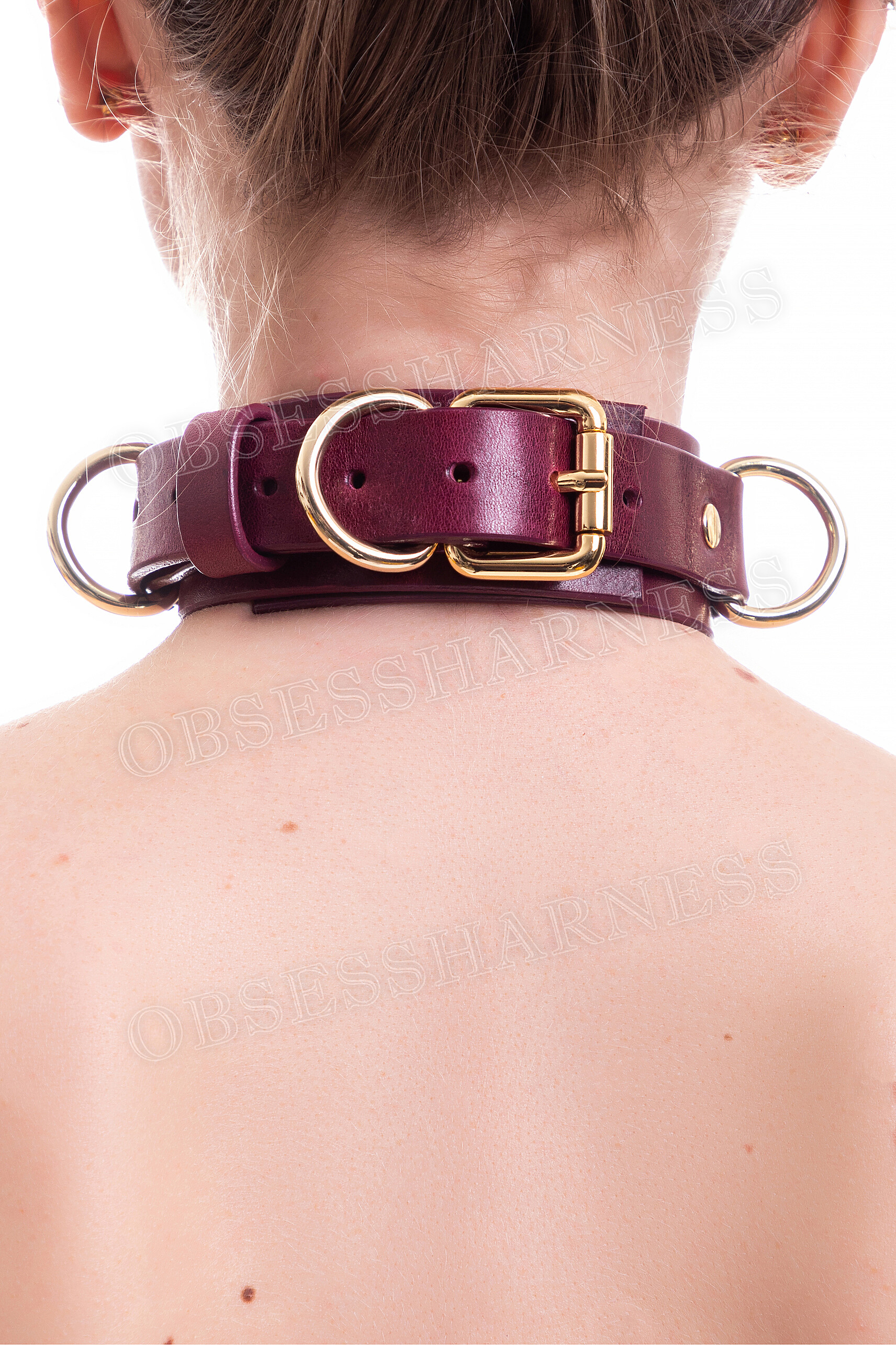 A woman in a Collar on the back of her neck with a chain leash to fasten to the metal rings on the Collar and train the slave in sex and BDSM role-playing games - Obsessharness